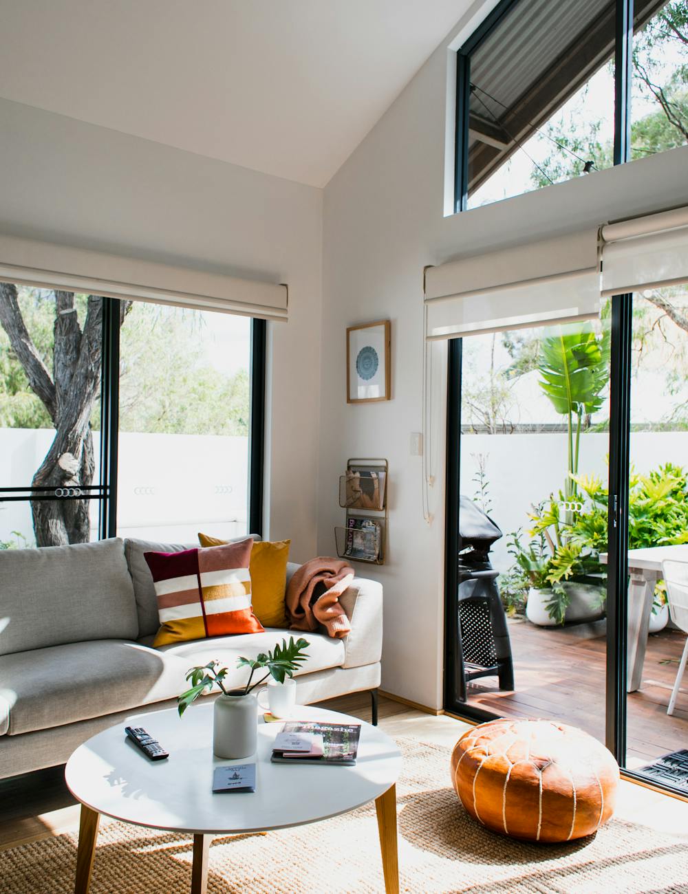 Sunlit living room with floor-to-ceiling glass and bright natural daylight
